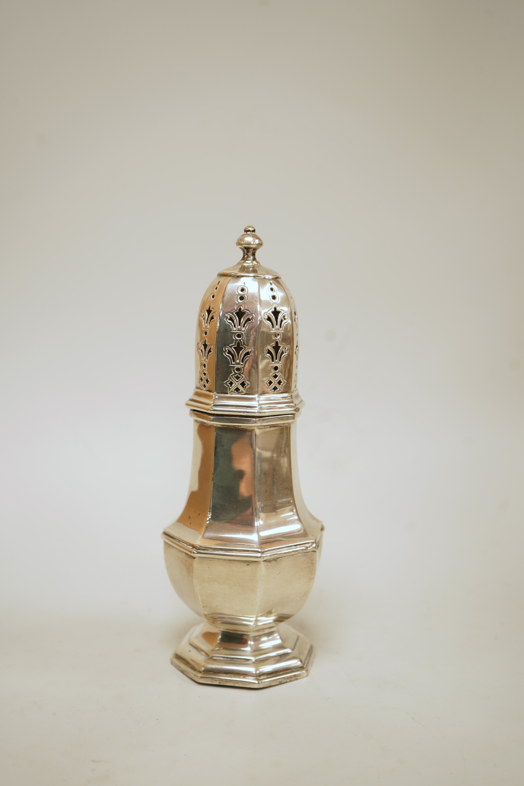 A George V silver octagonal silver sugar caster, by Mappin & Webb, Birmingham, 1930, height 16.7cm, 4.4oz.